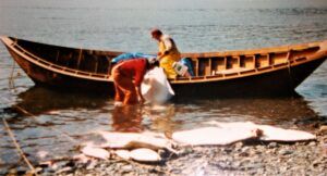 Wooden Opheim dory, fishermen, and halibut